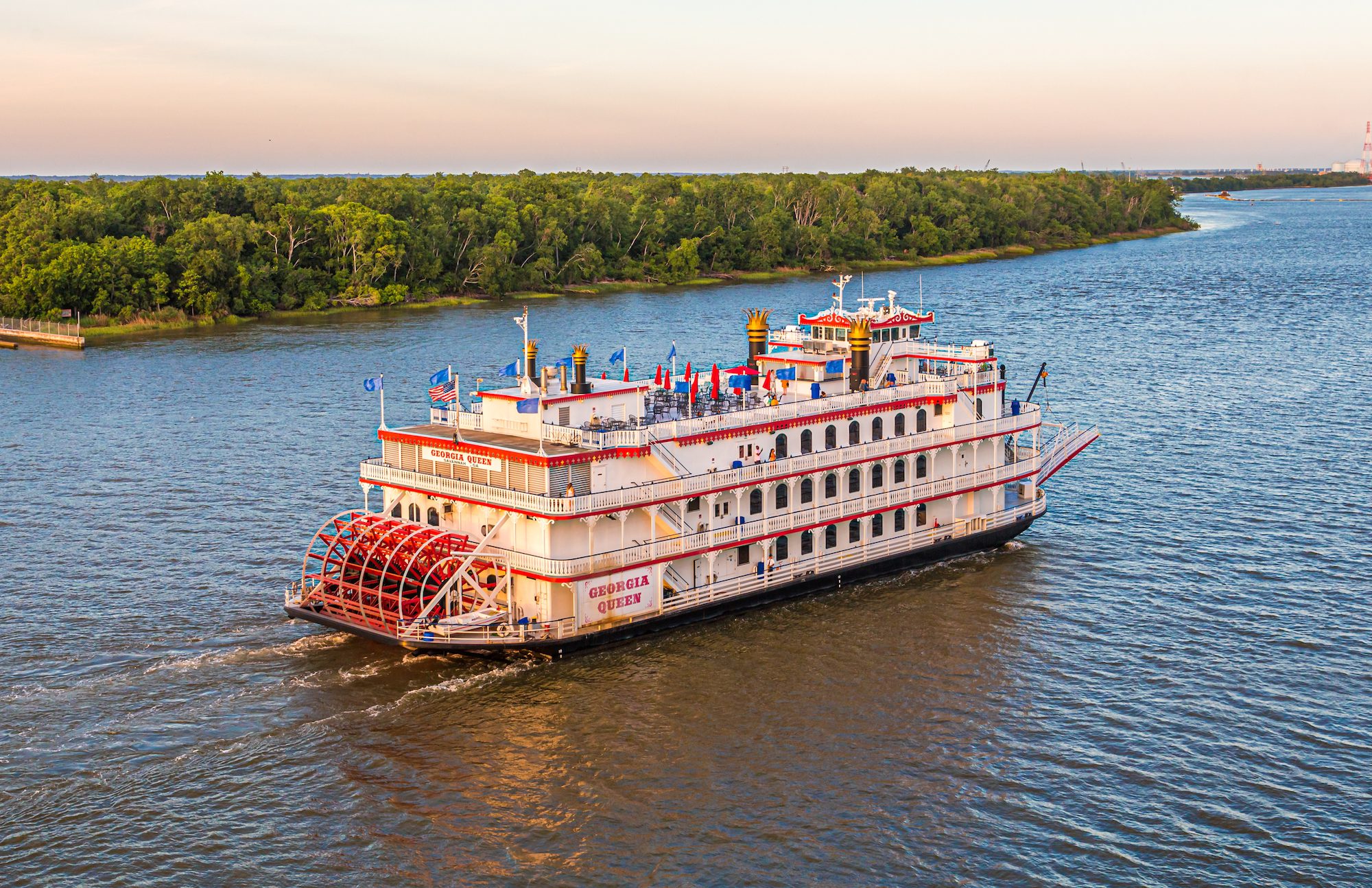 American Queen Voyages paddle steamer sailing on the river