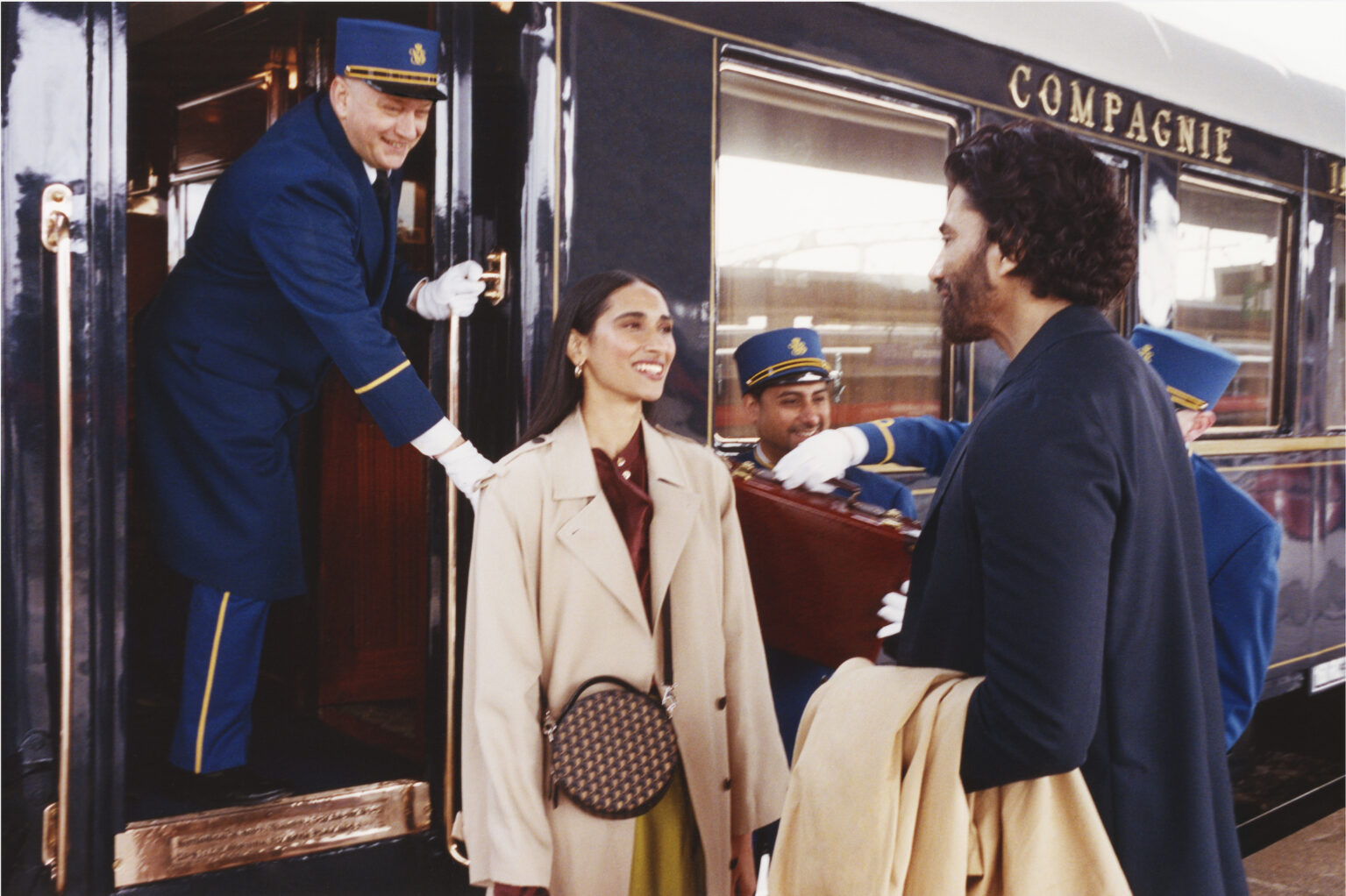 An attendant watches over as a couple depart the Orient Express. 