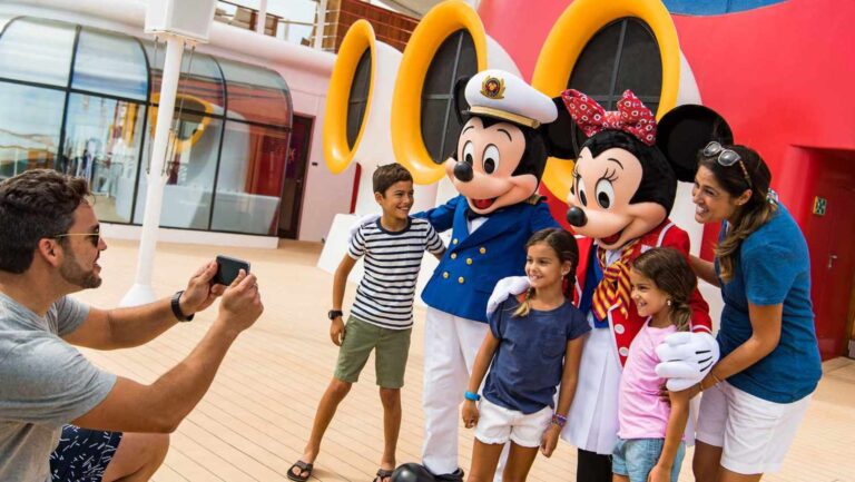 Disney Cruise Line's new season family taking a picture with Mickey and Minnie