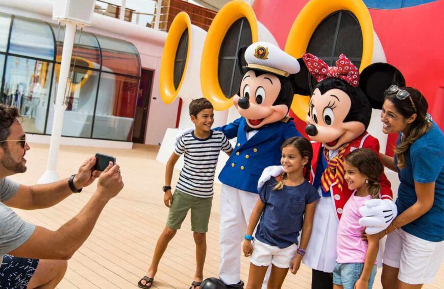 Disney Cruise Line's new season family taking a picture with Mickey and Minnie