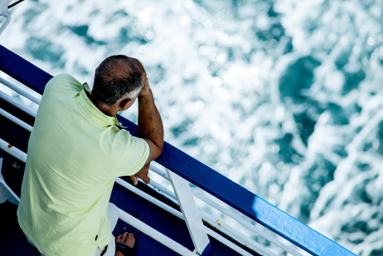 A man looks out at the ocean. 