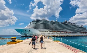 People walking towards a cruise ship in the Caribbean