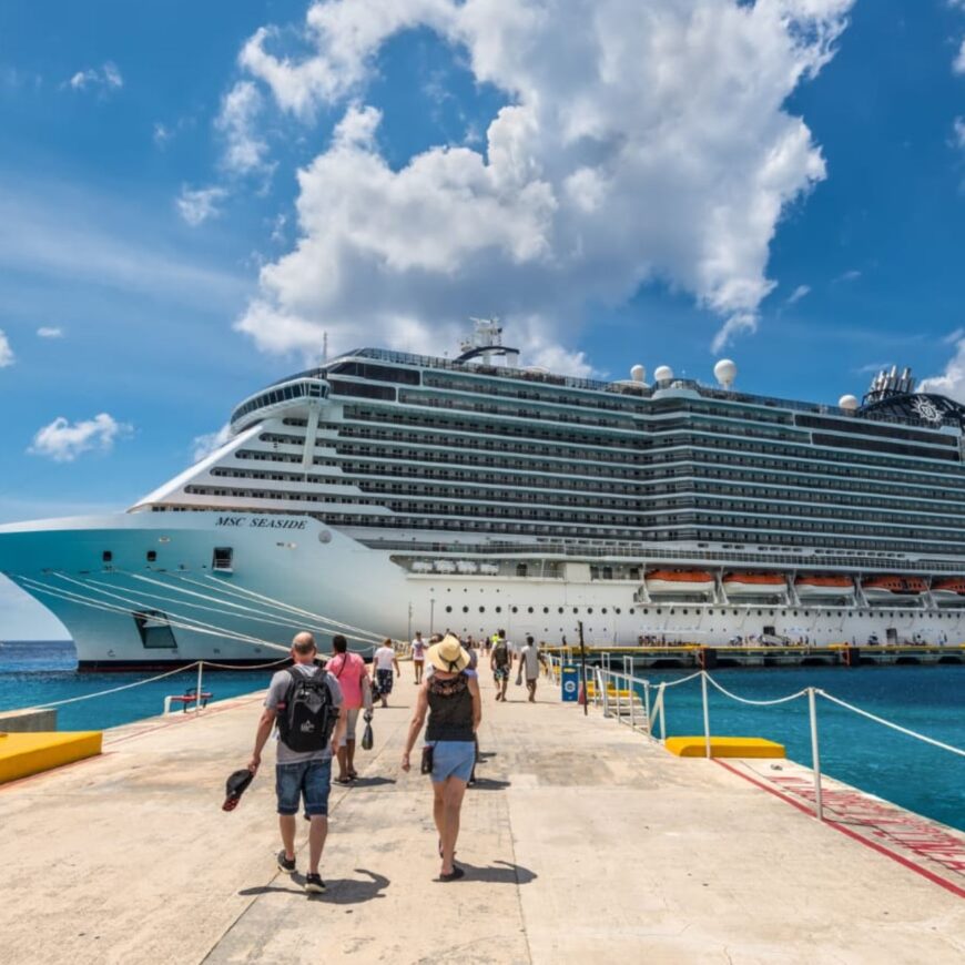 People walking towards a cruise ship in the Caribbean