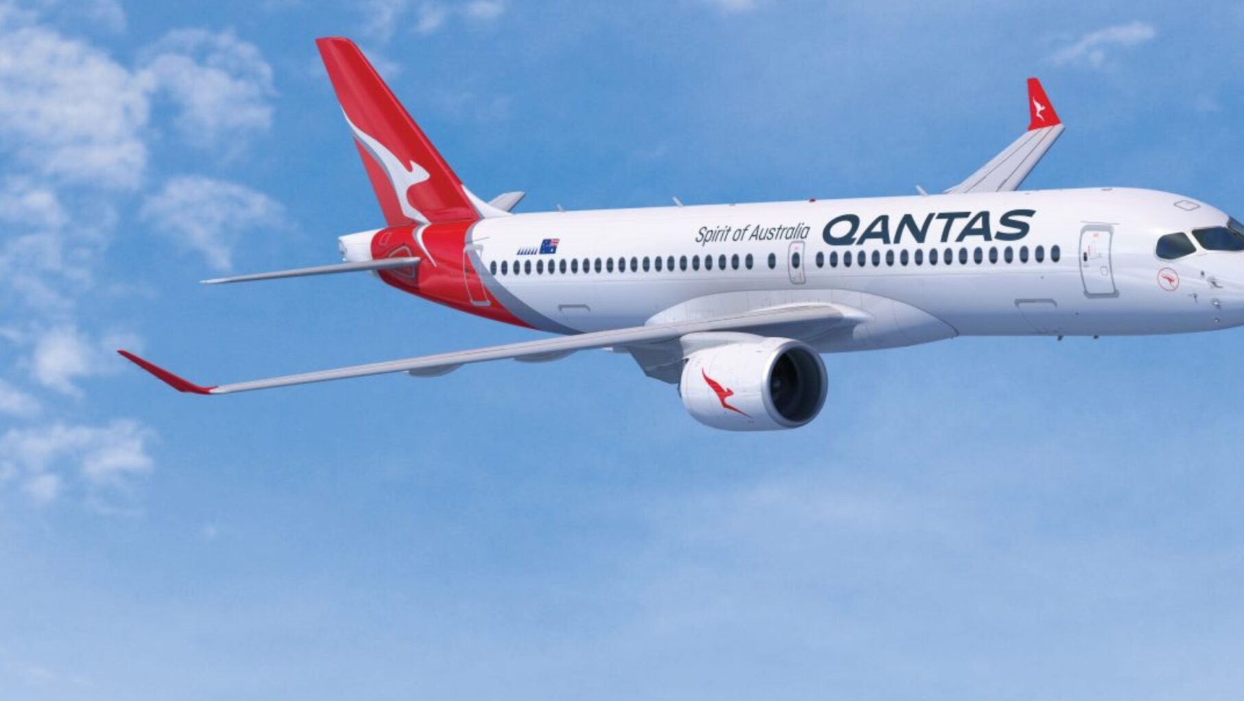 A Qantas Plane flies in the sky.