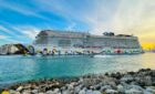 Norwegian Encore sailing in bright blue waters.