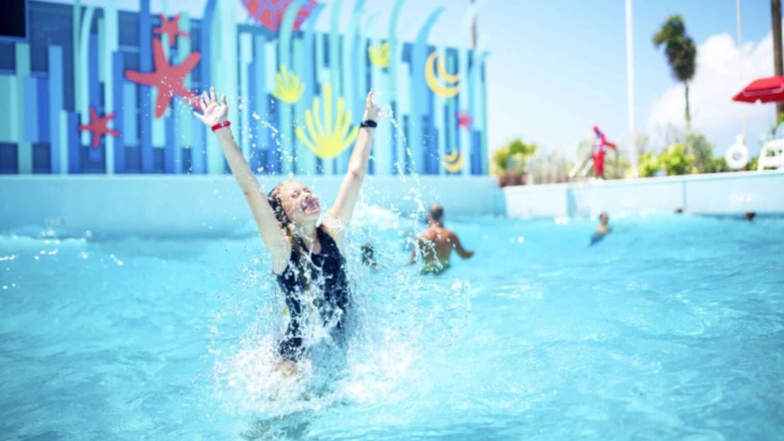 A child splashes around in a pool while Royal Caribbean prices increase.