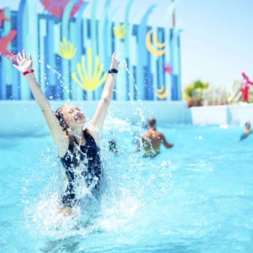 A child splashes around in a pool while Royal Caribbean prices increase.