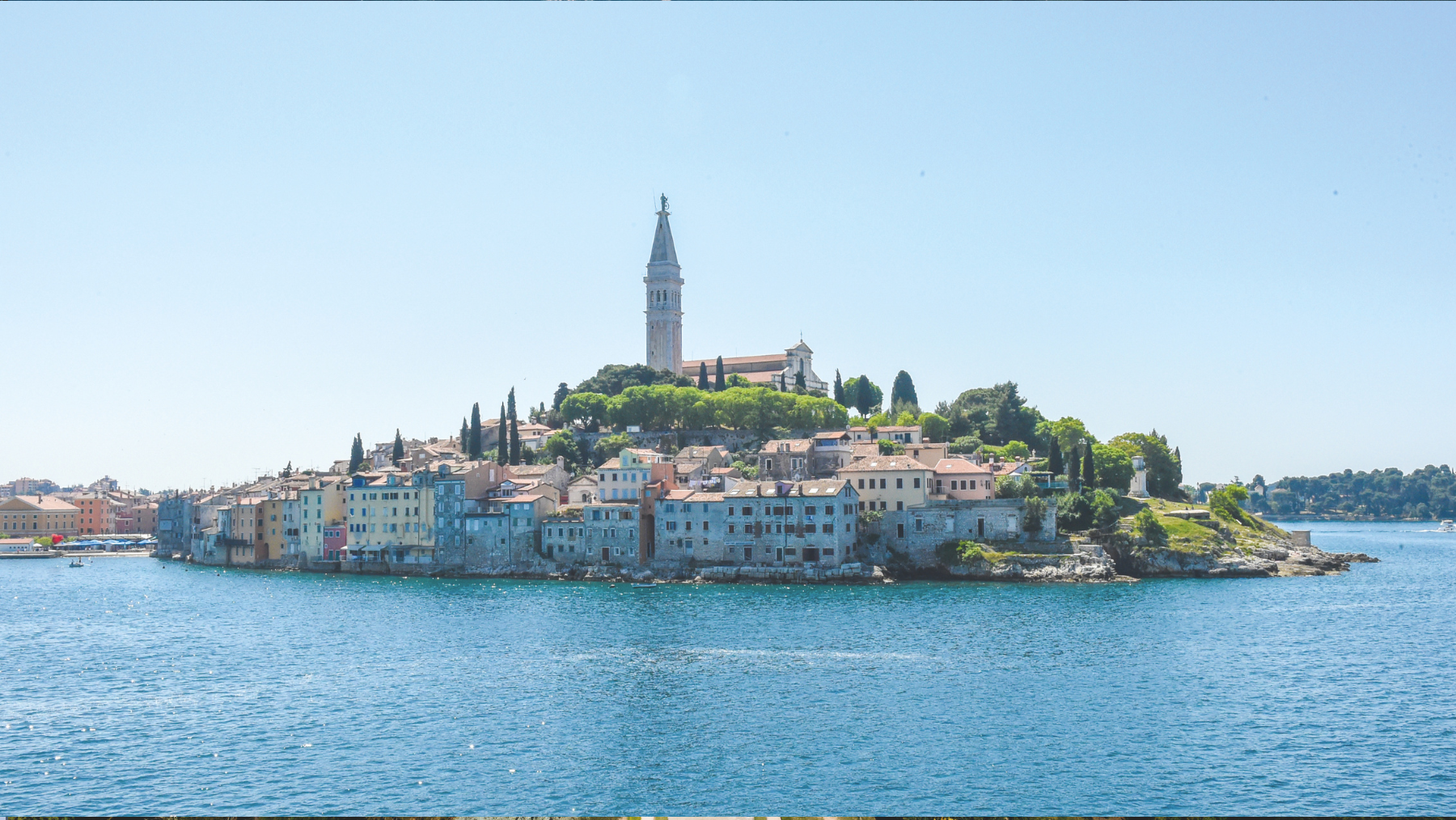 a city on a hill with a tower on the top