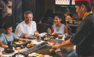 a group of people eating at a restaurant