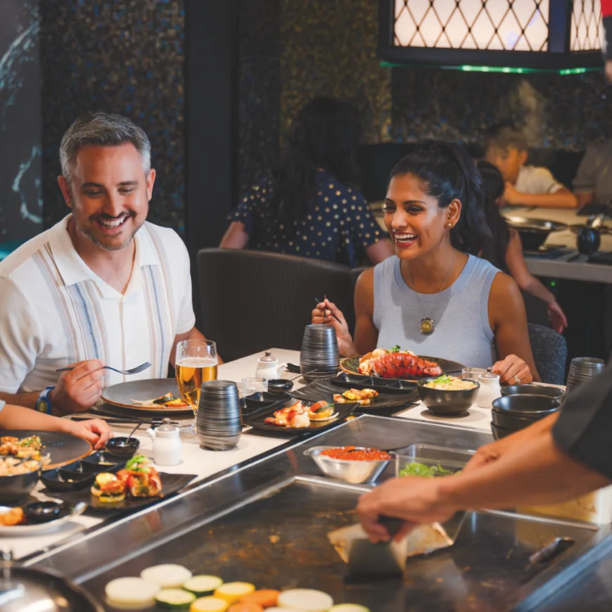 a group of people eating at a restaurant