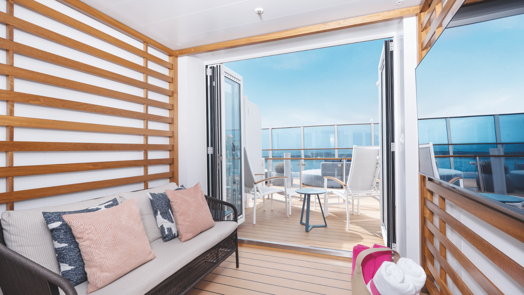 a room with a couch and chairs on a deck