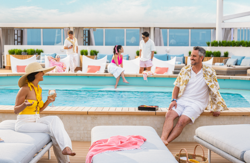 a group of people sitting on a pool deck