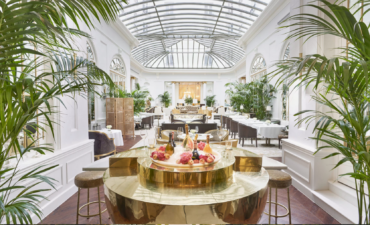 a room with a glass roof and tables and chairs of the Mandarin Oriental Ritz