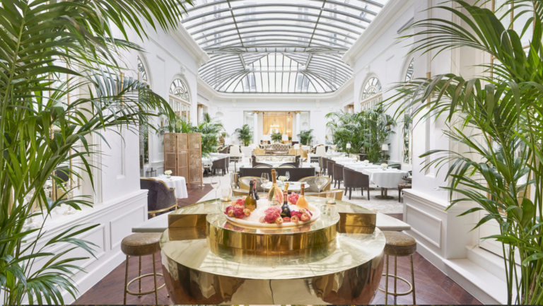 a room with a glass roof and tables and chairs of the Mandarin Oriental Ritz