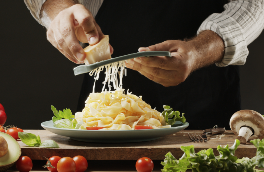 Grating cheese on fresh pasta