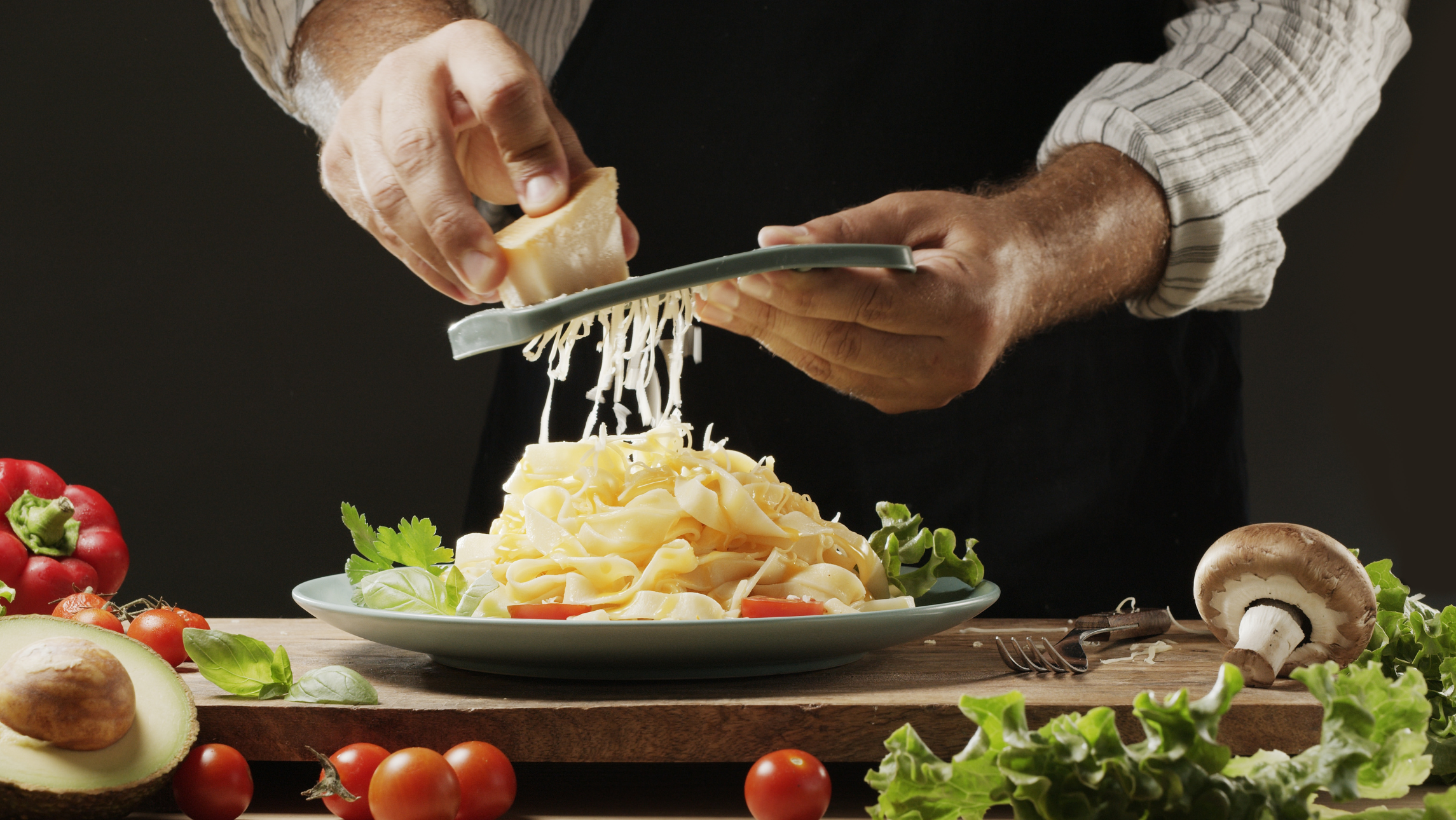 Grating cheese on fresh pasta