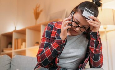 Woman frustrated on the telephone after a scam.