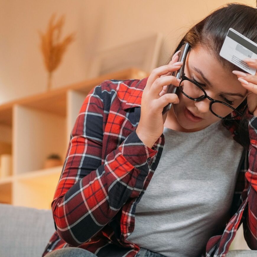 Woman frustrated on the telephone after a scam.