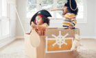 children role play, fantasy imagine or pretend in cardboard container.
