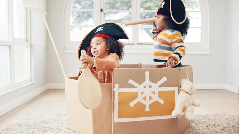 children role play, fantasy imagine or pretend in cardboard container.