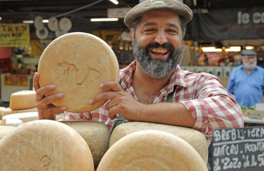 man with cheese in market