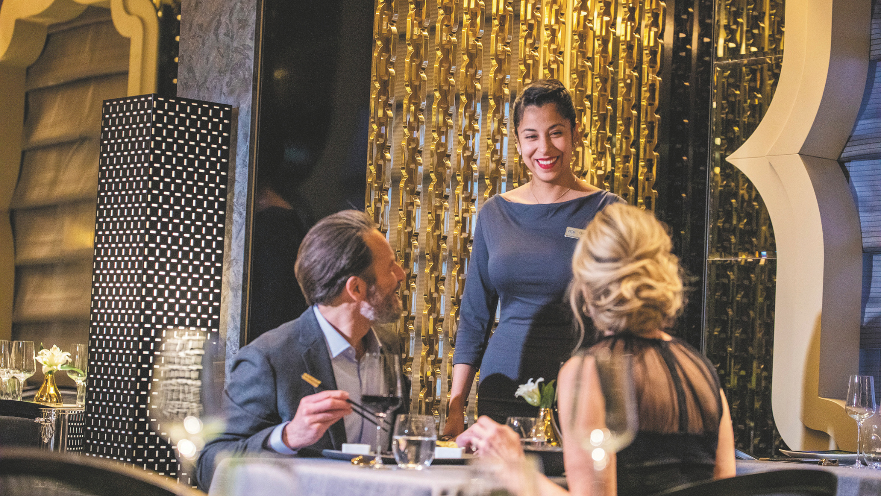 Two people dining at a restaurant at Regent Seven Seas. 