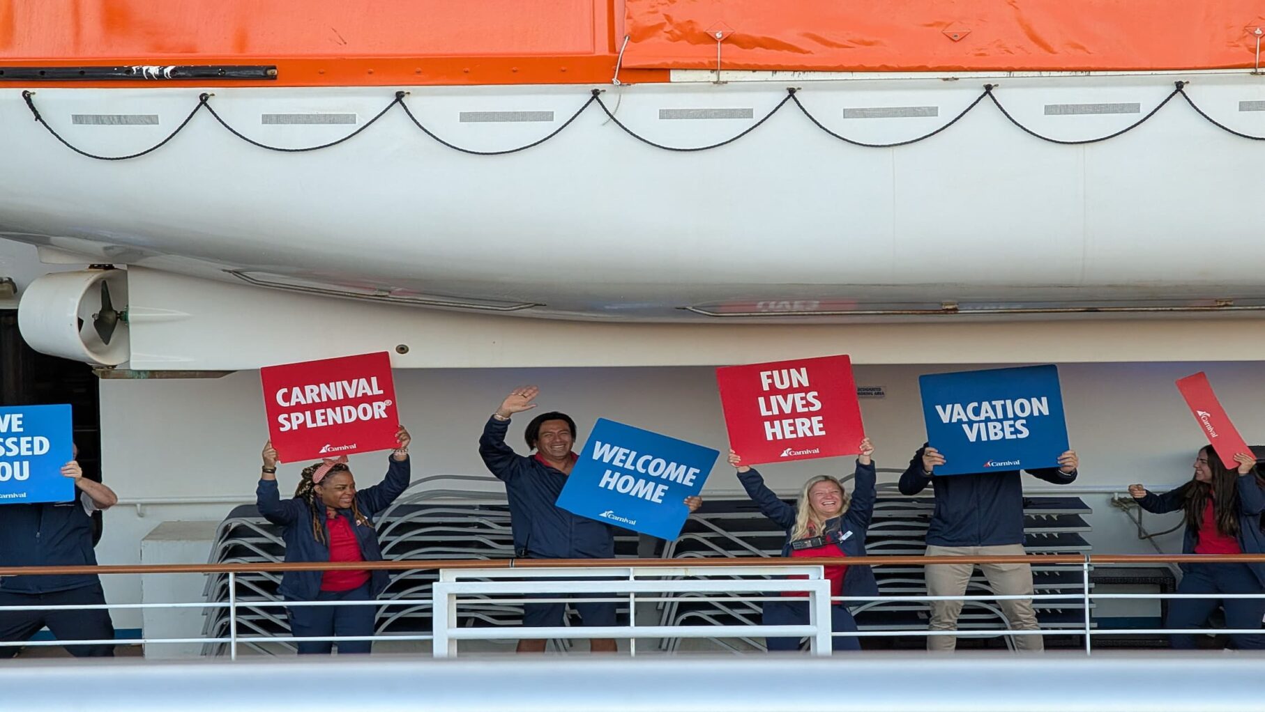 Crew members welcoming passengers onboard Carnival Splendor