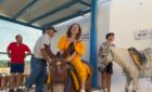 Woman rides Santorini donkeys