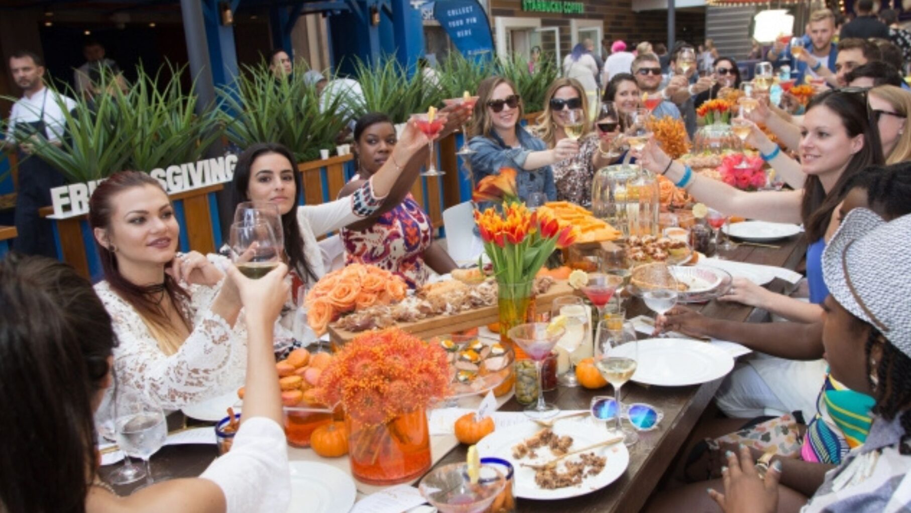 Royal Caribbean passengers eating dinner and raising a toast.