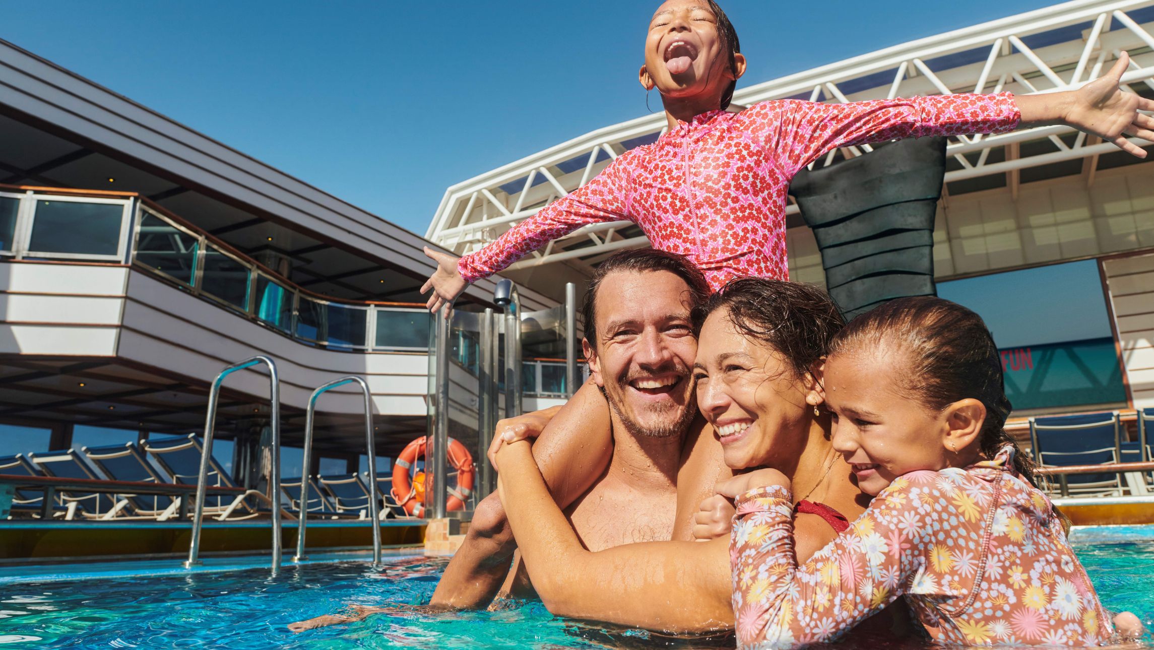 A family onboard in the pool the new Carnival Cruise Line's 2026/27 itineraries