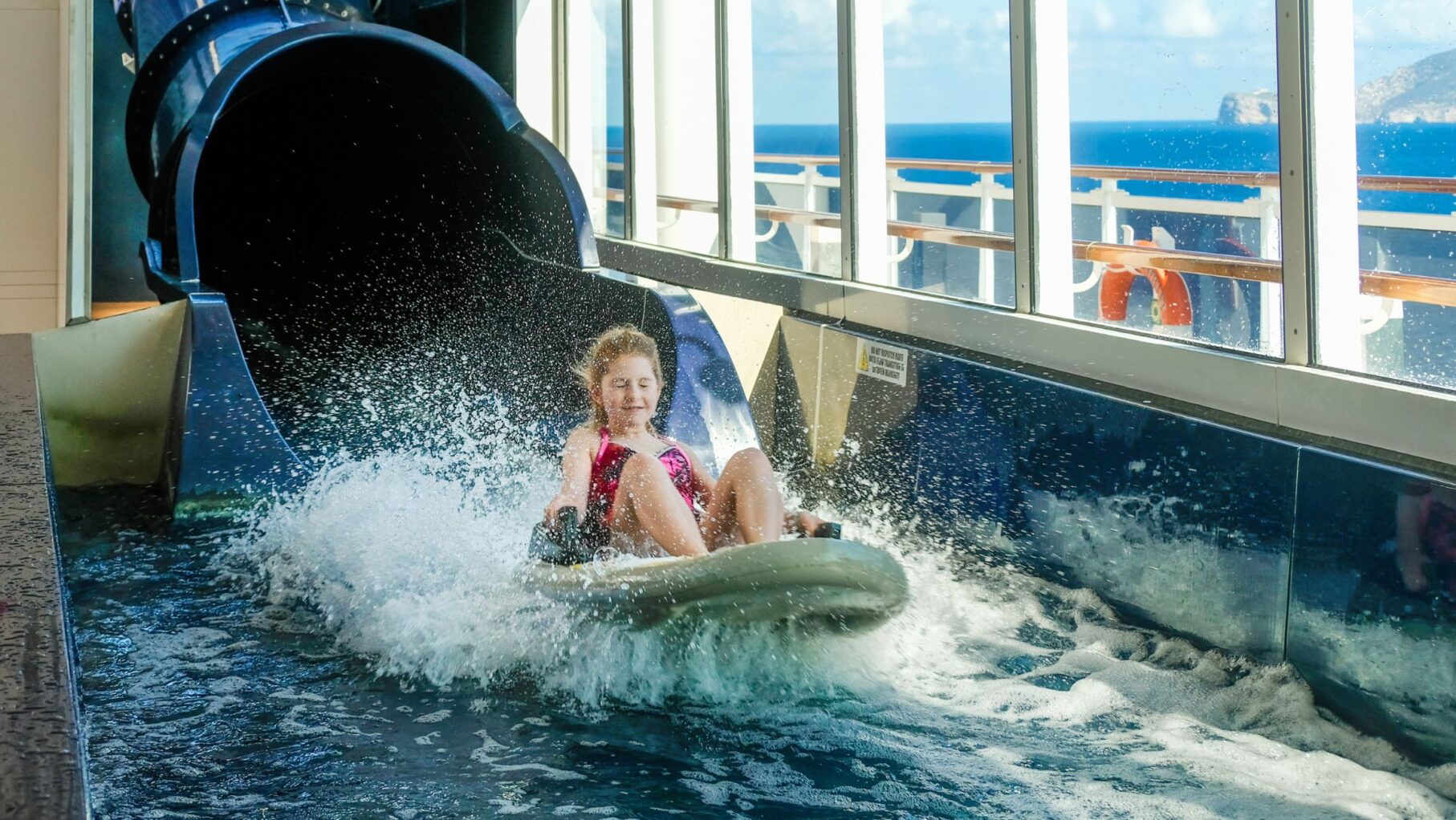 A child on a cruise ship slide.