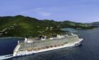 An NCL ship cruising by an island.