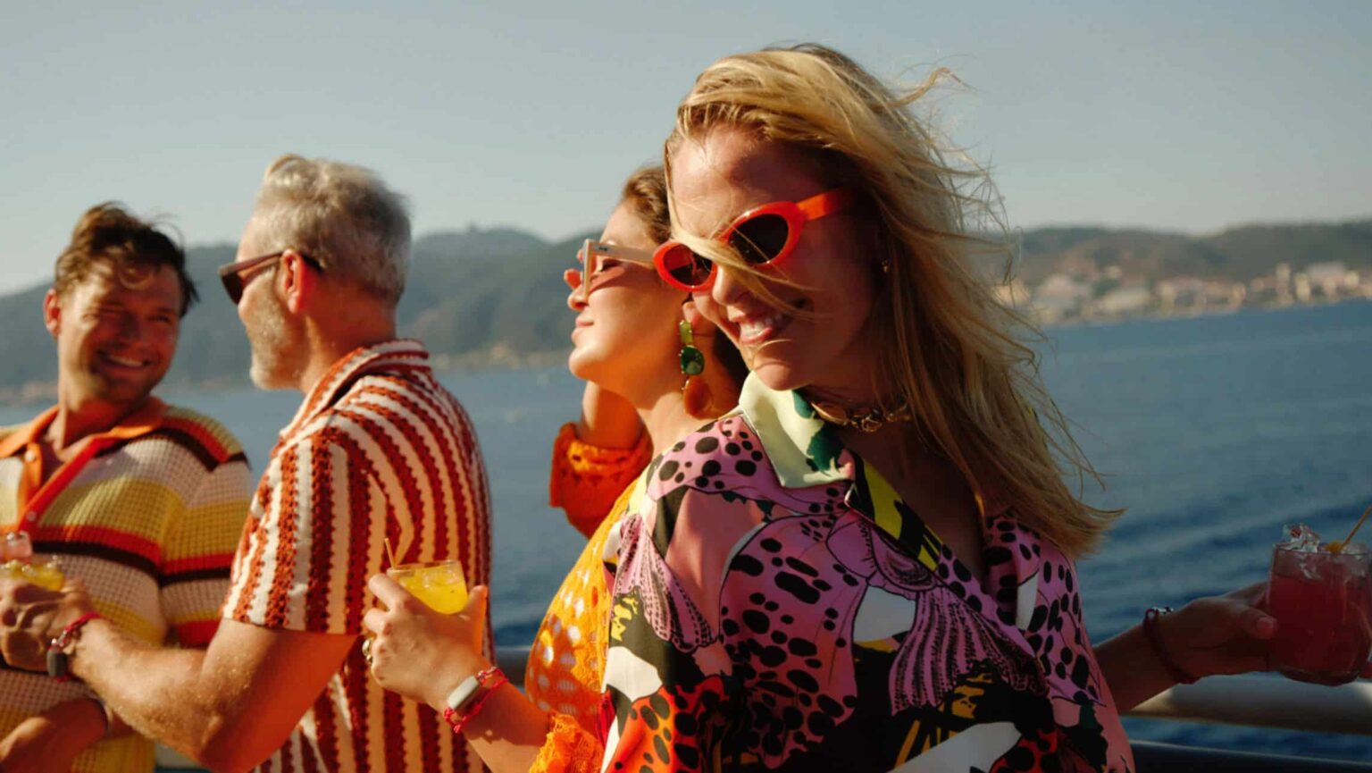 Cruise passenger sipping her drink on virgin voyages.