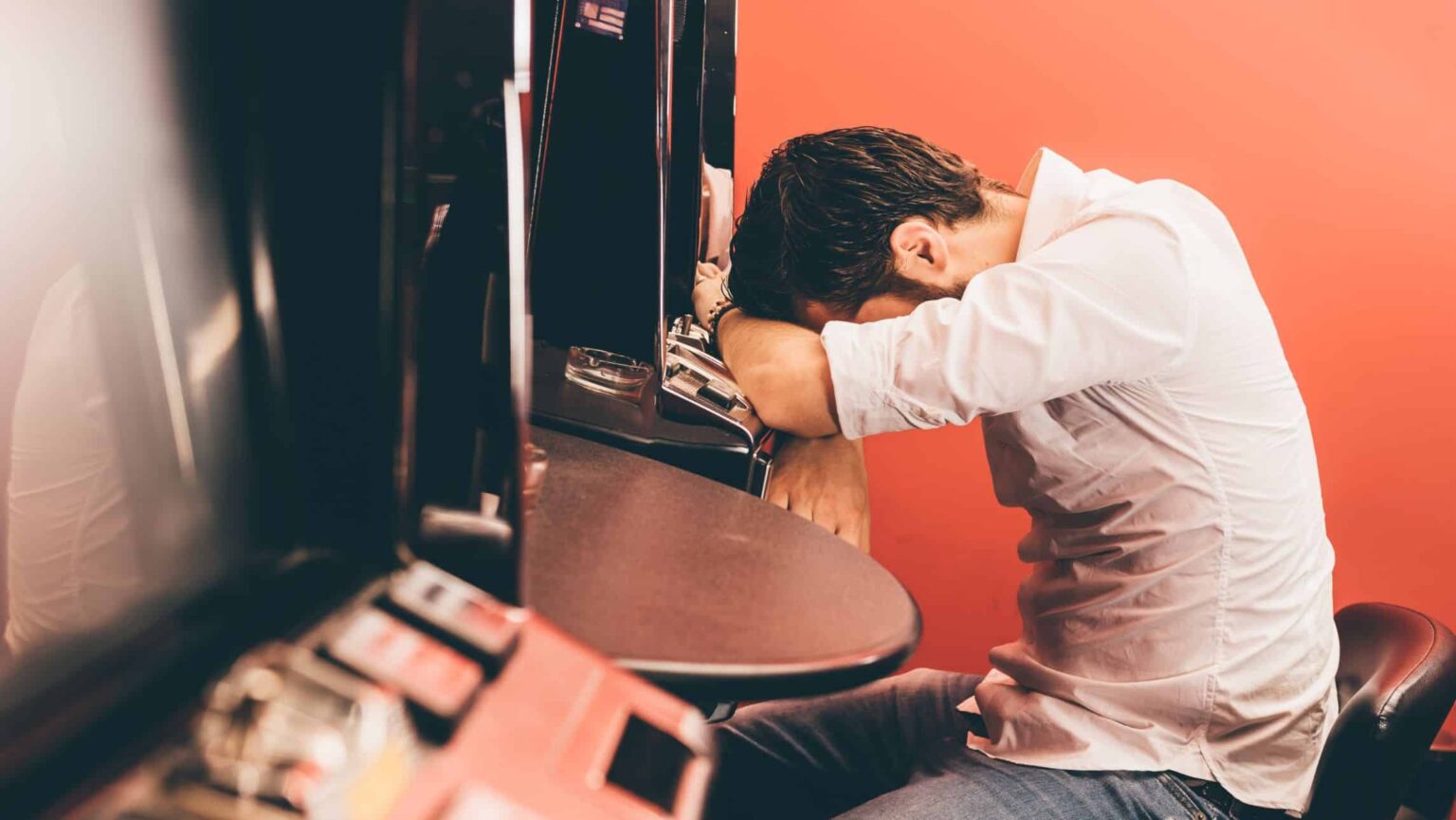 Gambling looking sad in casino.