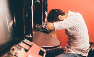 Gambling looking sad in casino.