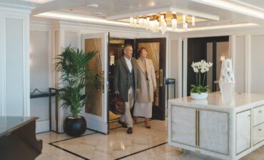 A couple walking into the Owner's Suite on a Regent Seven Seas ship