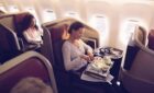 A woman enjoying her dinner on a Latam business class flight