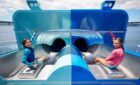 Two kids on a water slide