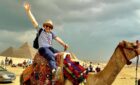 peter lynch riding a camel in the Egyptian desert