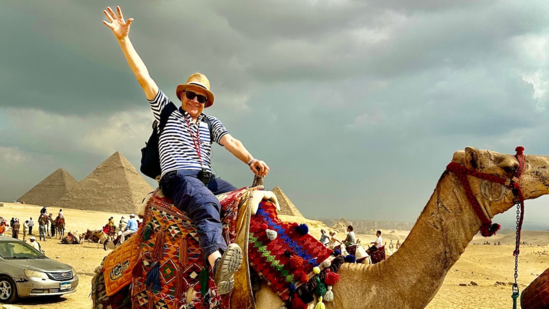 peter lynch riding a camel in the Egyptian desert