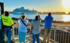 People watching cruise ship leave