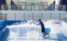 A man surfs on Anthem of the Seas