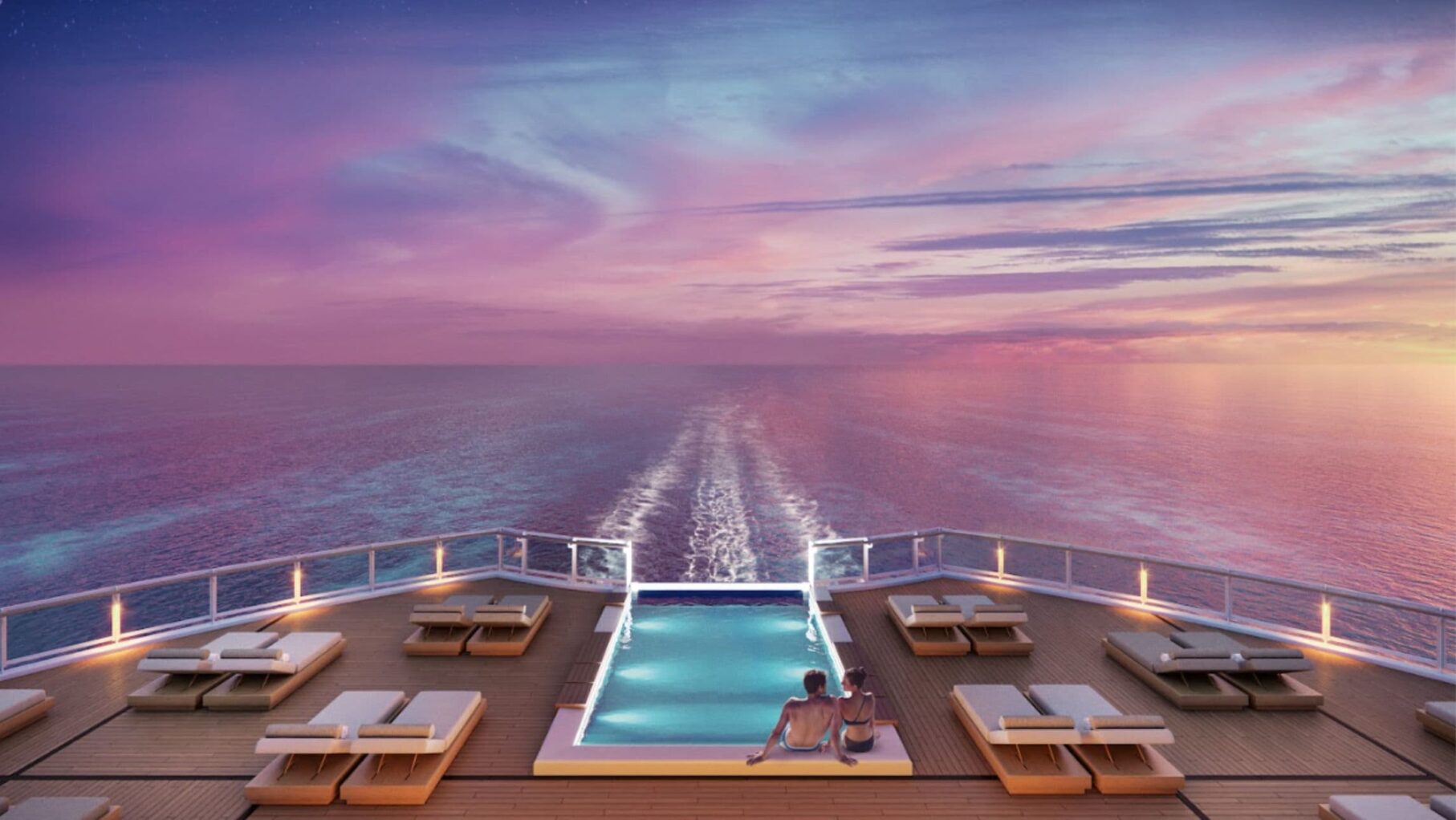 Guests sit by the pool on the Norwegian Viva Haven Sundeck