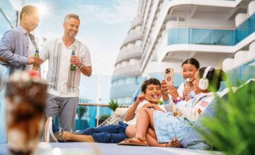 A family have fun on a Royal Caribbean cabana deck loyalty program