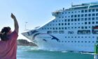 woman waving goodbye to P and O pacific explorer ship near the port