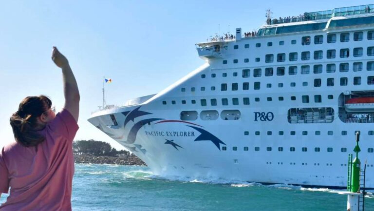 woman waving goodbye to P and O pacific explorer ship near the port