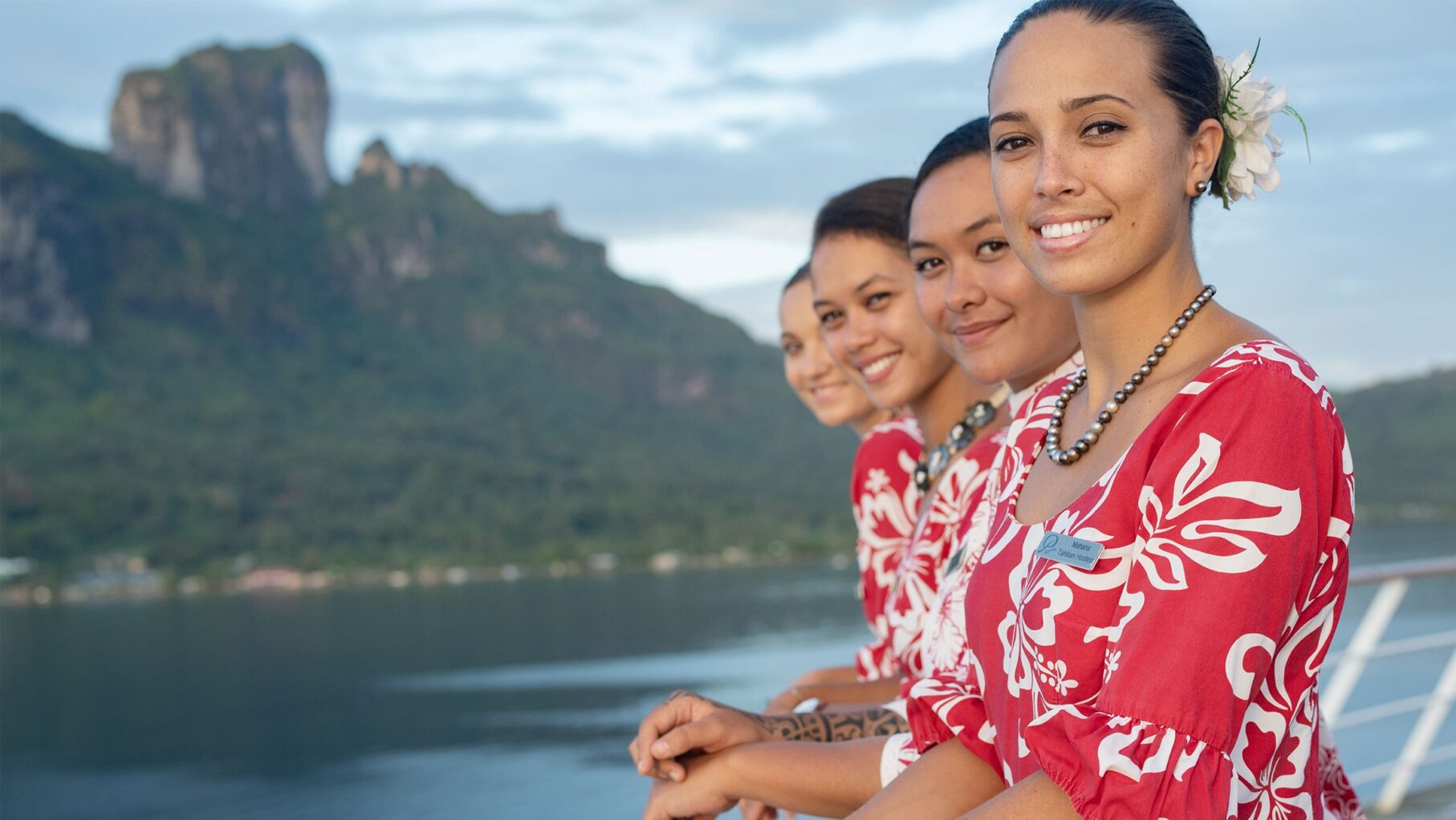 4 Tahitian hostesses smile on a Paul Gaugin ship