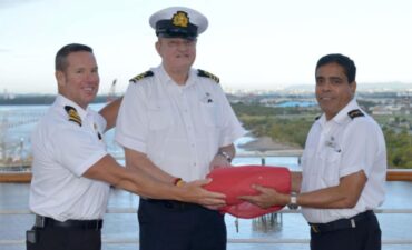 crew members wrap up the red flag of P&O at closing of P&O australia