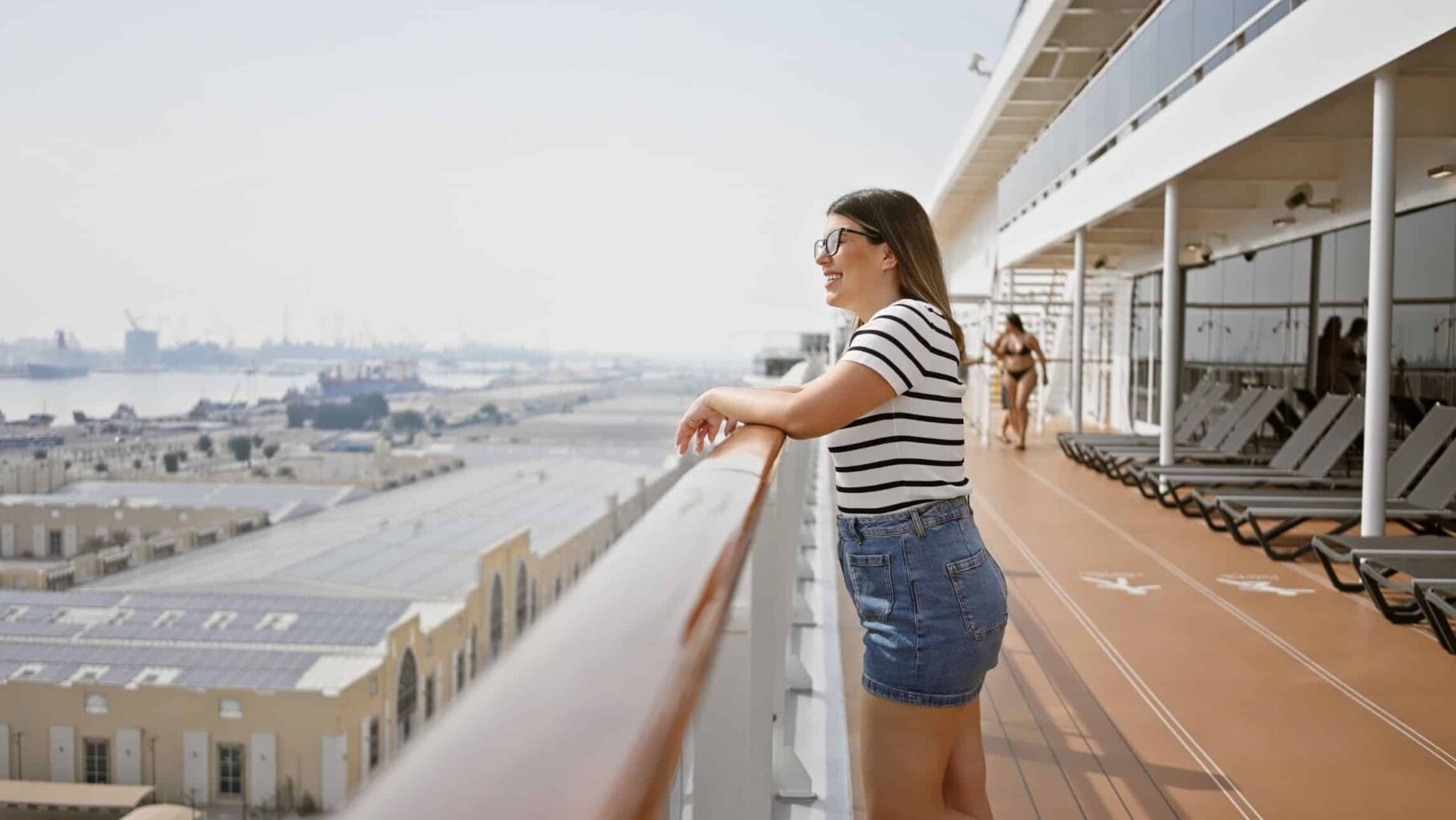 a woman wears jeans on a cruise ship