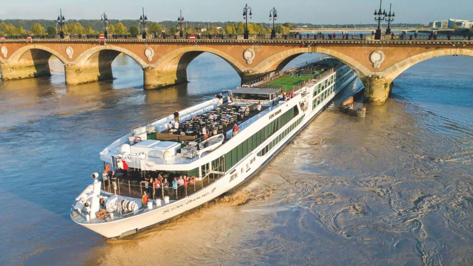 a river ship cruising down a river